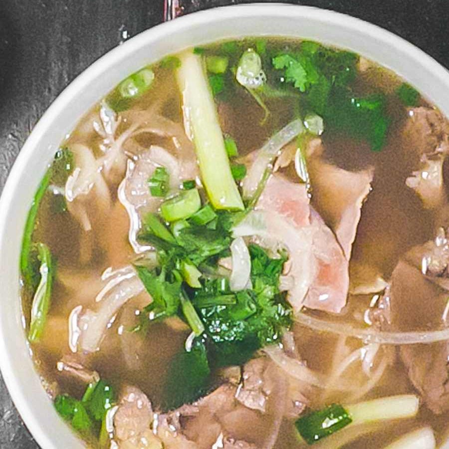 Phở Đặc Biệt — beef pho with eye round, brisket, scallion and cilantro