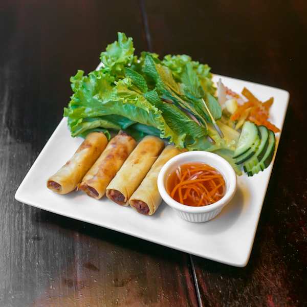 Chả Giò — four crispy spring rolls with lettuce, mint, cucumber, and fish sauce